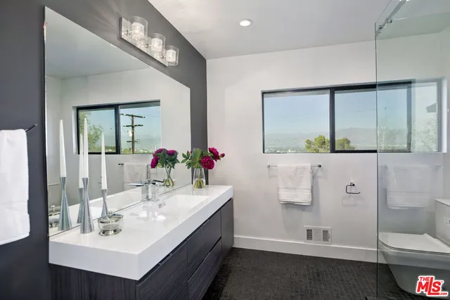 a spacious bedroom with a bed and a large window