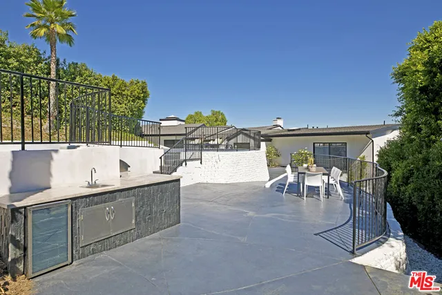a bedroom with a bed a table and chairs