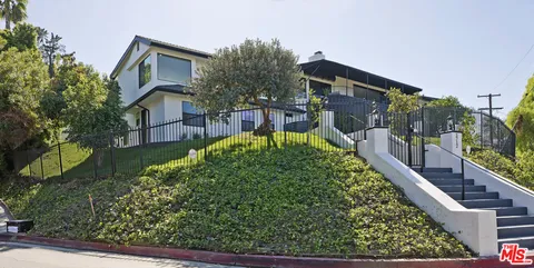 an aerial view of a house with a swimming pool patio and outdoor seating