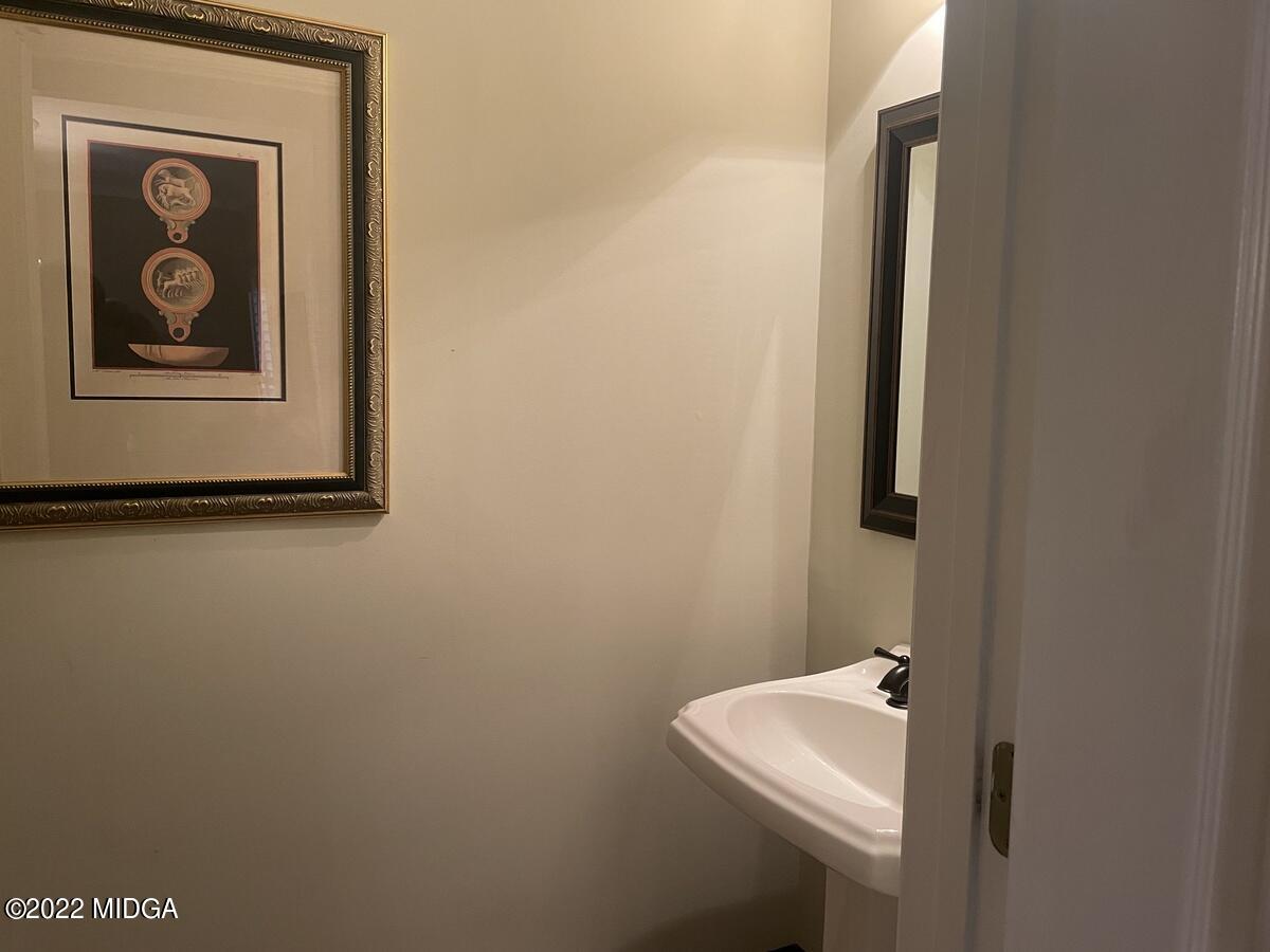 1715 Maynards Mill Road Forsyth, GA 31029 - Photo 12 of 36 a bathroom with a toilet and sink