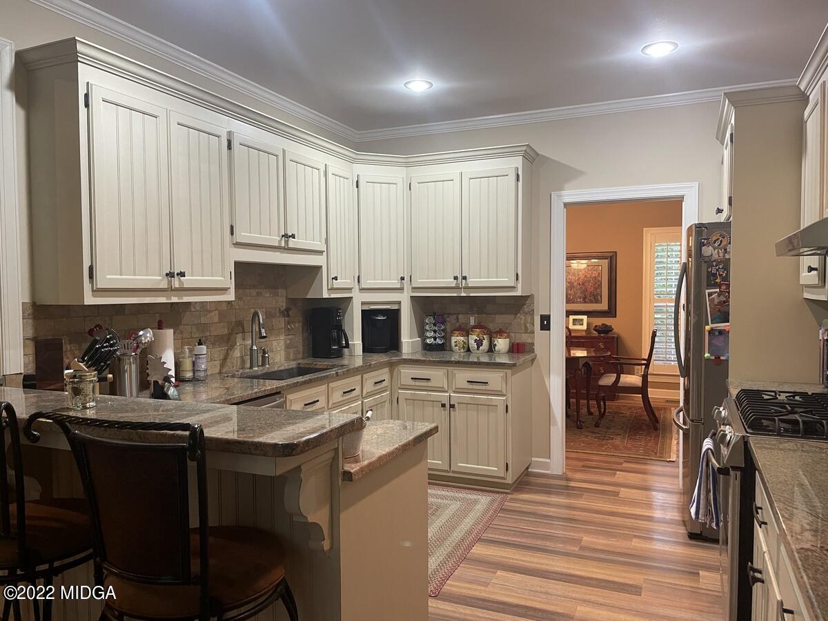 1715 Maynards Mill Road Forsyth, GA 31029 - Photo 14 of 36 a kitchen with a refrigerator stove and white cabinets