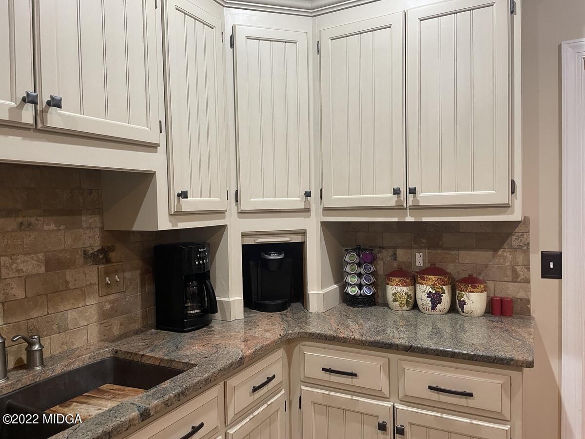 1715 Maynards Mill Road Forsyth, GA 31029 - Photo 15 of 36 a kitchen with granite countertop cabinets and white appliances