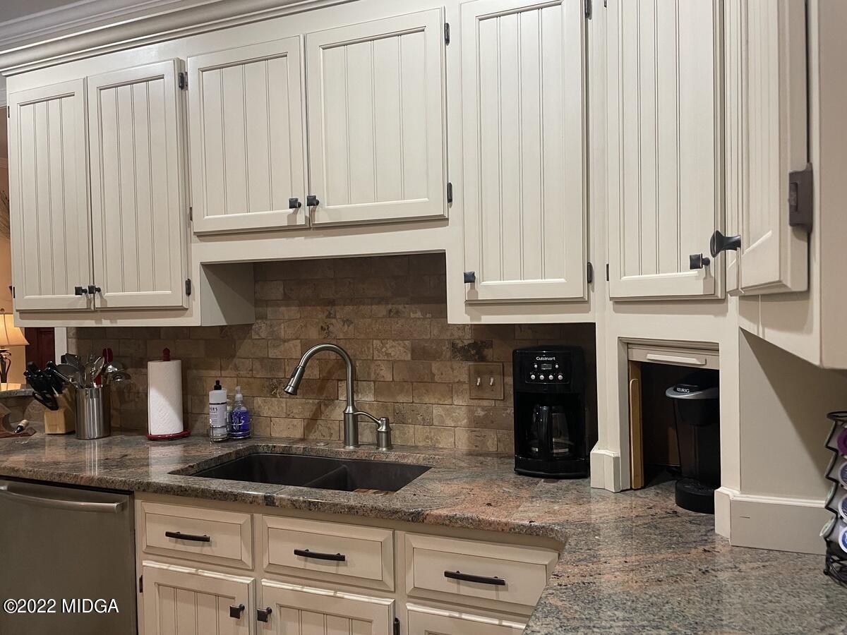 1715 Maynards Mill Road Forsyth, GA 31029 - Photo 16 of 36 a kitchen with granite countertop a sink and cabinets