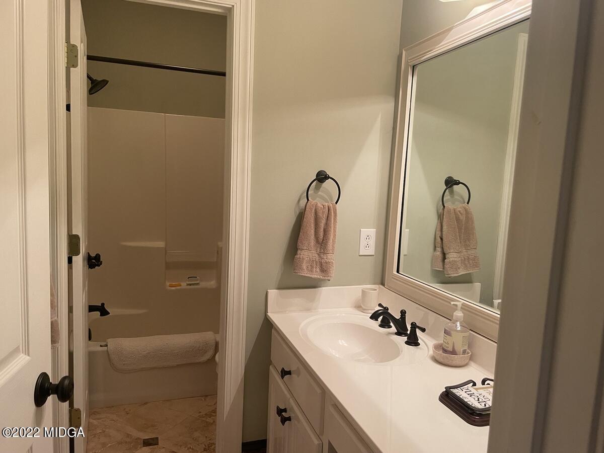 1715 Maynards Mill Road Forsyth, GA 31029 - Photo 17 of 36 a bathroom with a sink and a mirror