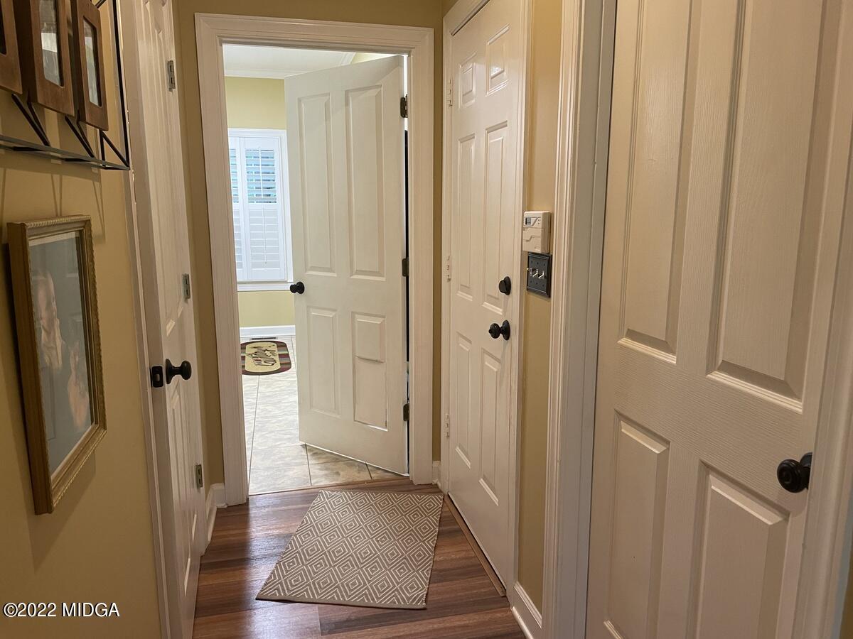 1715 Maynards Mill Road Forsyth, GA 31029 - Photo 22 of 36 a view of a hallway with wooden floor and staircase