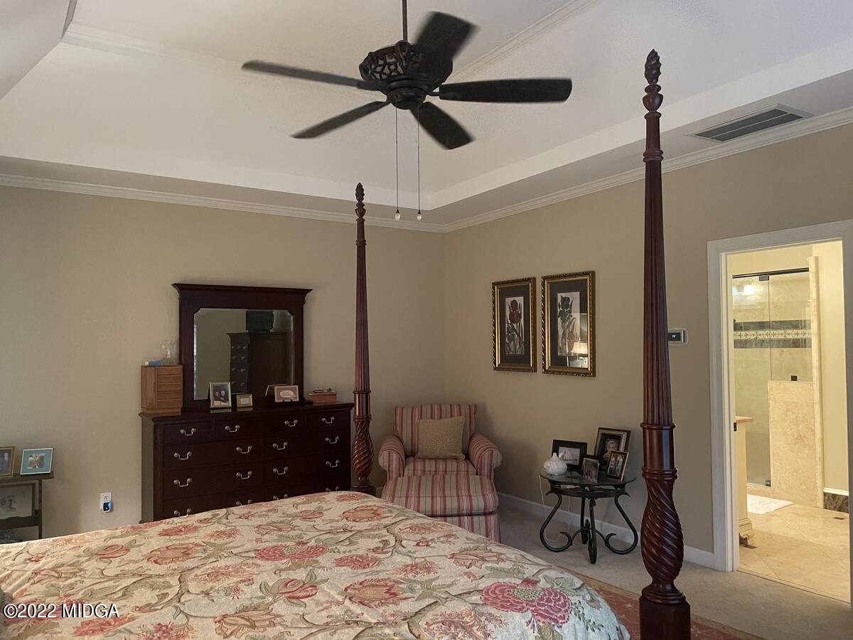 1715 Maynards Mill Road Forsyth, GA 31029 - Photo 24 of 36 a bedroom with a bed and a chandelier