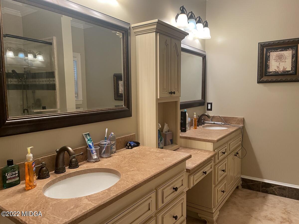 1715 Maynards Mill Road Forsyth, GA 31029 - Photo 26 of 36 a bathroom with double vanity sinks and a mirror