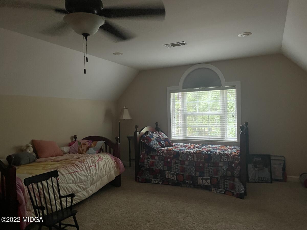 1715 Maynards Mill Road Forsyth, GA 31029 - Photo 29 of 36 a bedroom with bed and a window