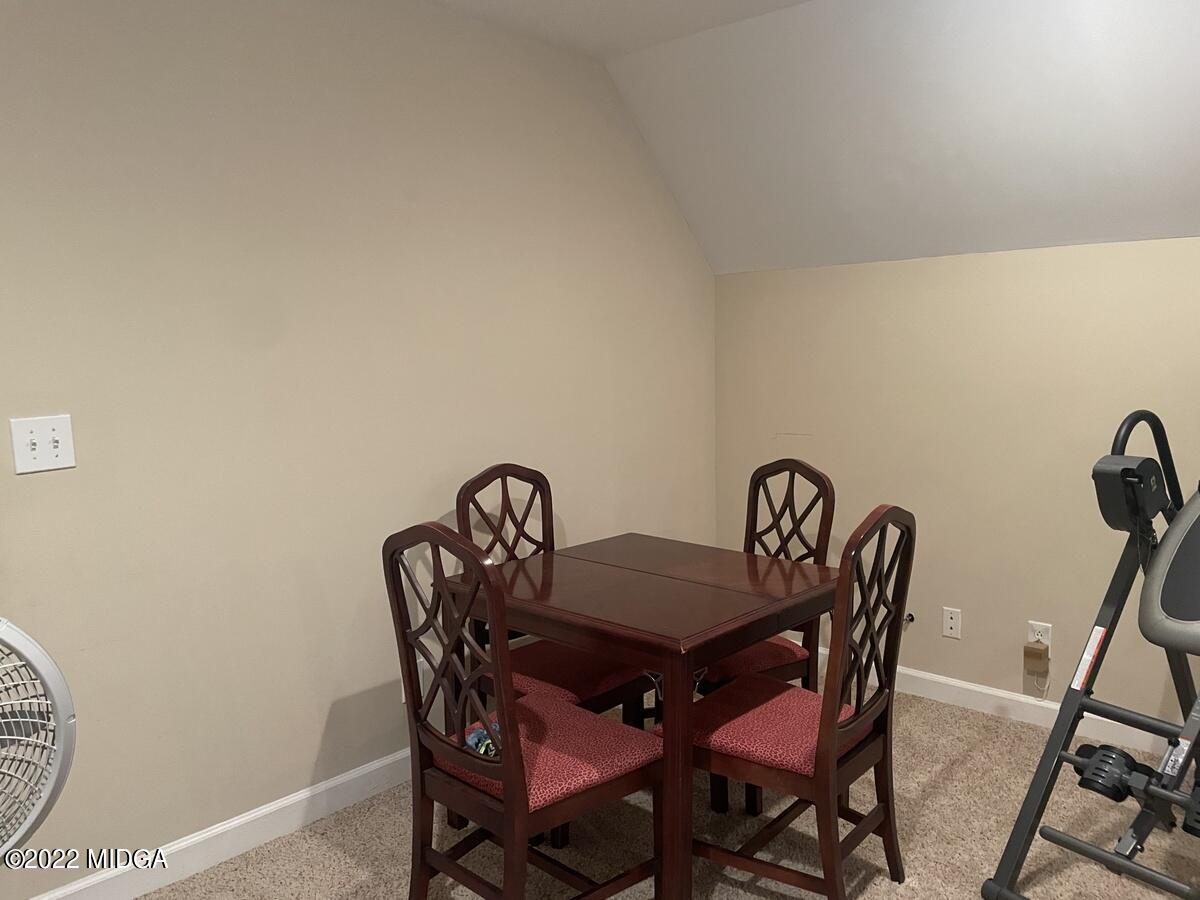 1715 Maynards Mill Road Forsyth, GA 31029 - Photo 30 of 36 a view of a dining room with furniture and wooden floor