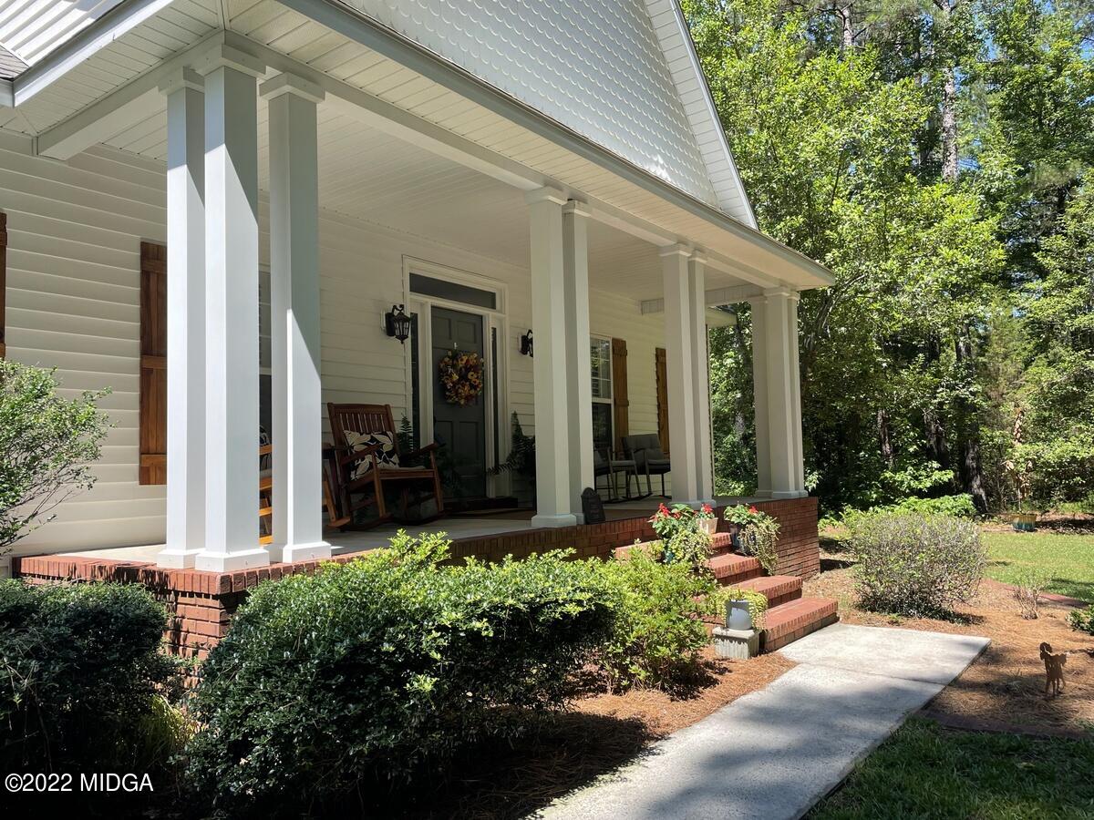 1715 Maynards Mill Road Forsyth, GA 31029 - Photo 3 of 36 a front view of a house with garden