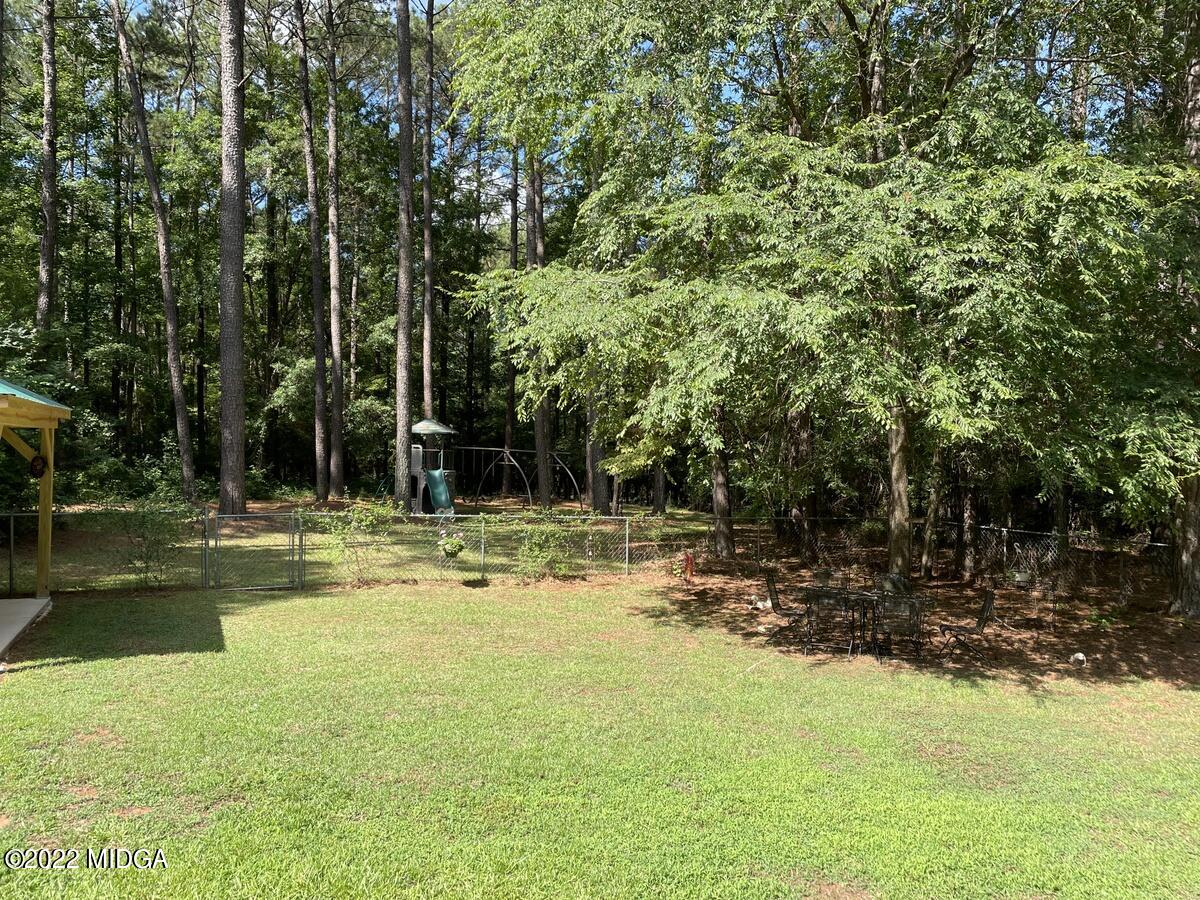 1715 Maynards Mill Road Forsyth, GA 31029 - Photo 36 of 36 a view of a swimming pool with lawn chairs and plants