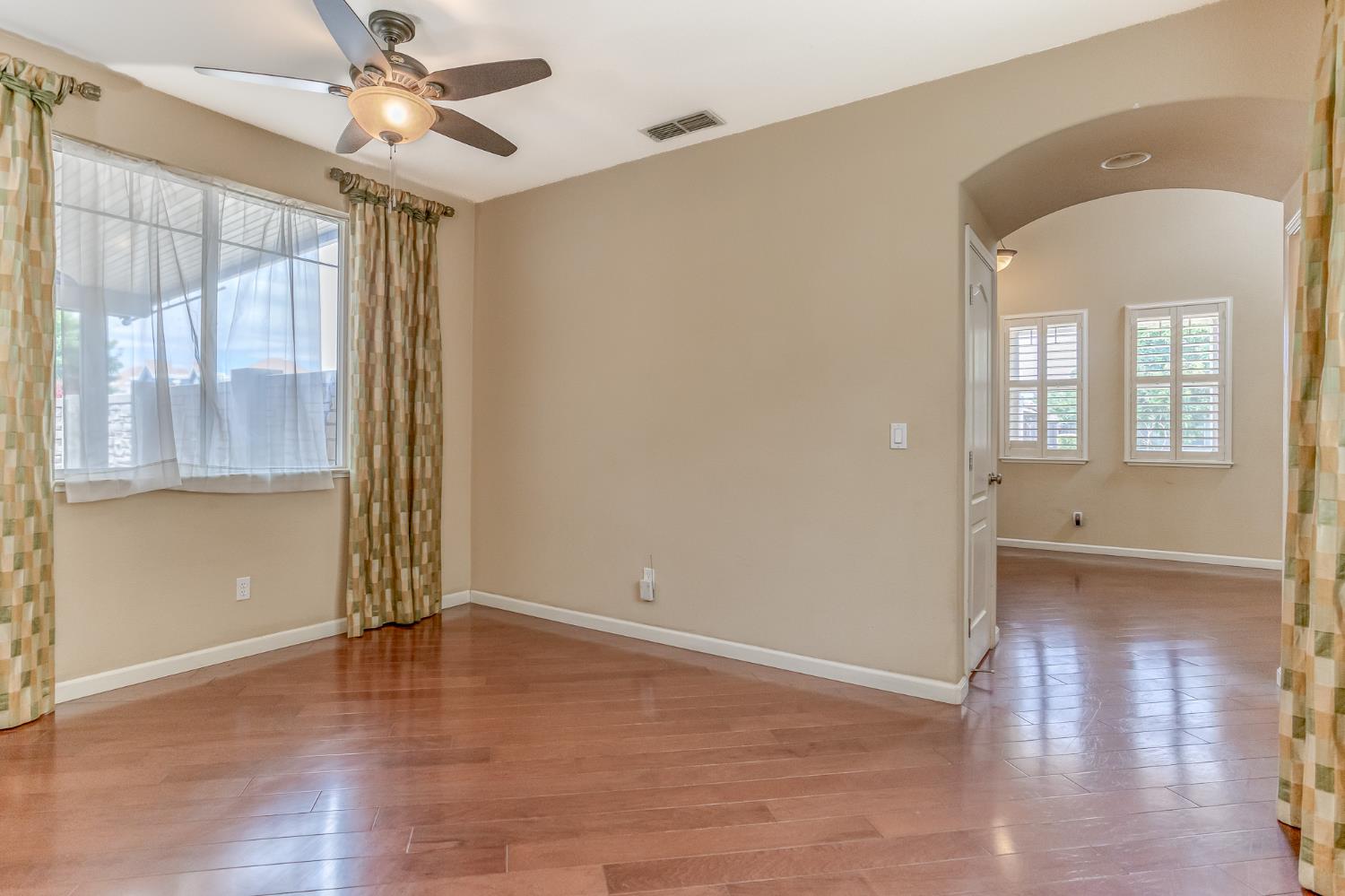 188 Thomsen Road Lathrop, CA 95330 - Photo 9 of 27 wooden floor in an empty room with a window