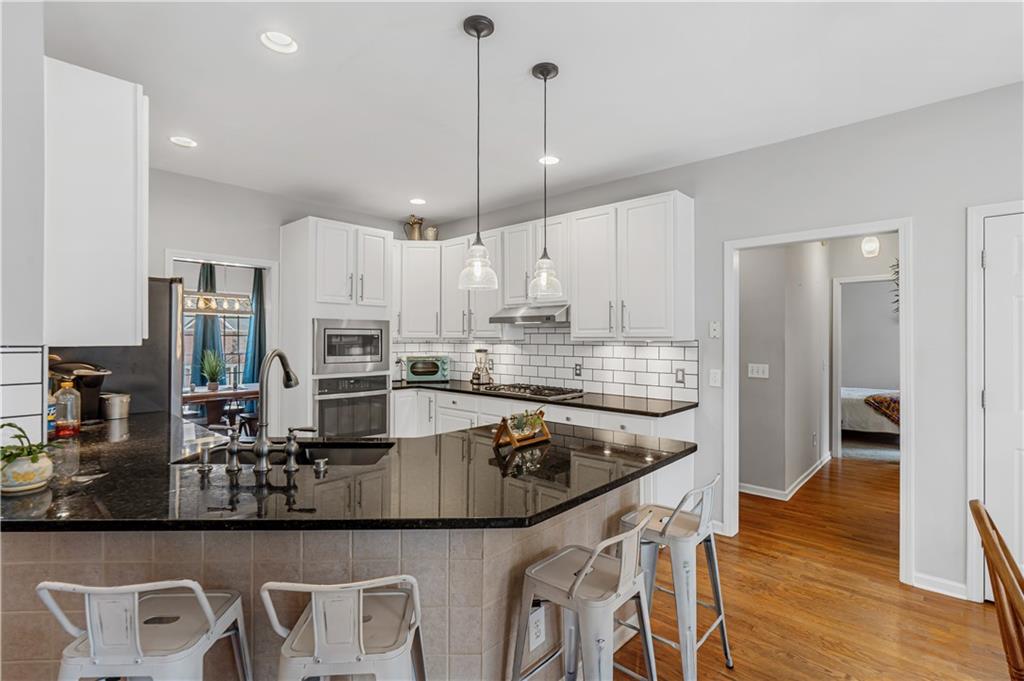 860 Valley Drive Canton, GA 30114 - Photo 12 of 62 a kitchen with stainless steel appliances granite countertop a sink refrigerator and cabinets