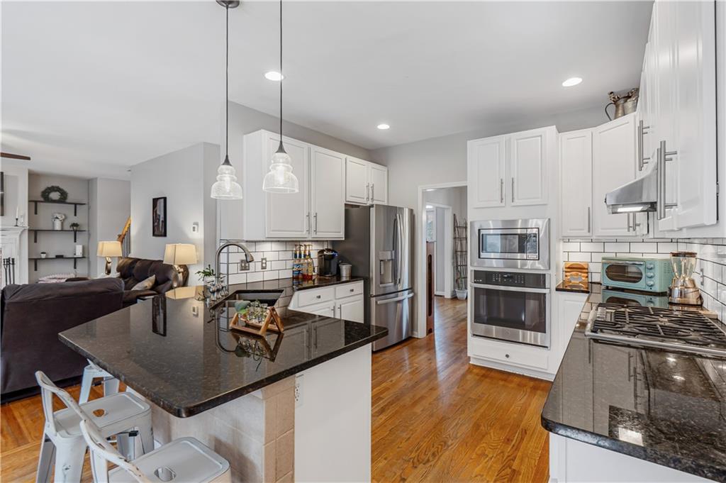 860 Valley Drive Canton, GA 30114 - Photo 13 of 62 a kitchen with stainless steel appliances granite countertop a sink refrigerator and cabinets