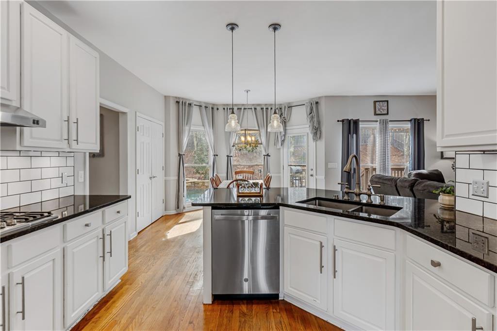 860 Valley Drive Canton, GA 30114 - Photo 15 of 62 a large kitchen with granite countertop a lot of counter space and wooden floor