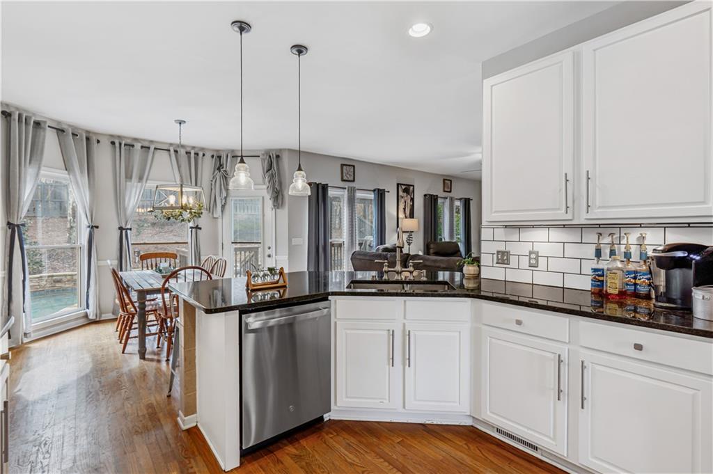 860 Valley Drive Canton, GA 30114 - Photo 16 of 62 a kitchen with stainless steel appliances granite countertop a sink and cabinets