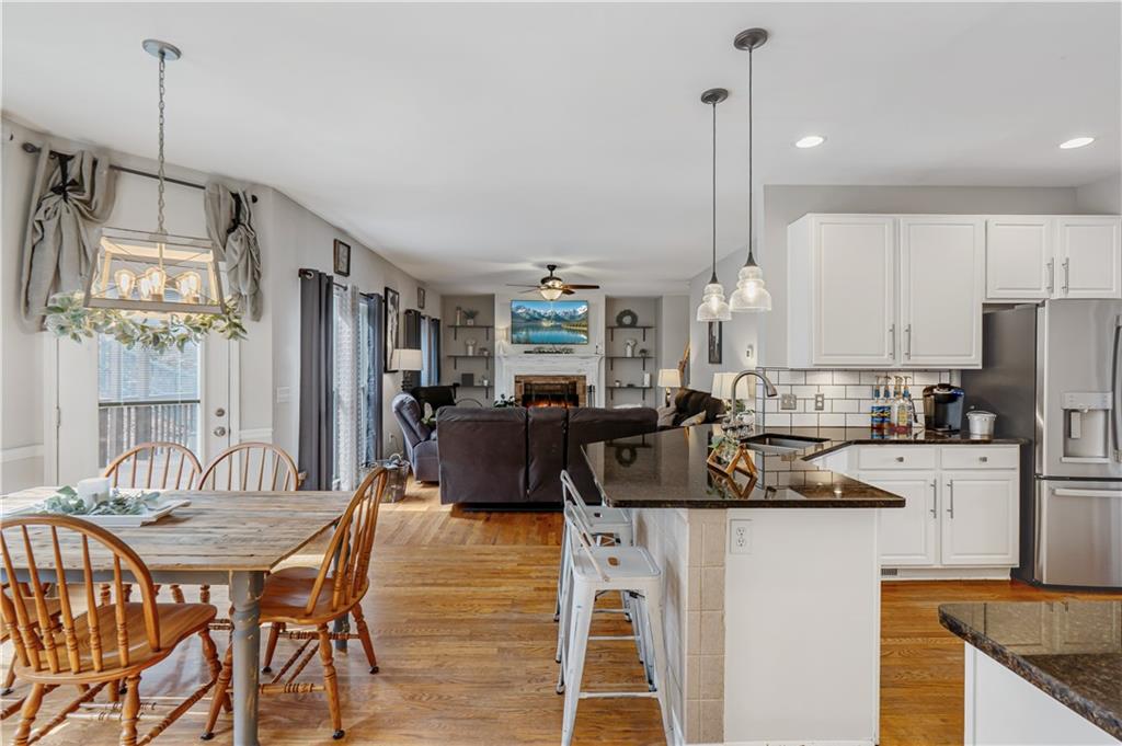 860 Valley Drive Canton, GA 30114 - Photo 17 of 62 a kitchen with a refrigerator a stove a dining table and chairs