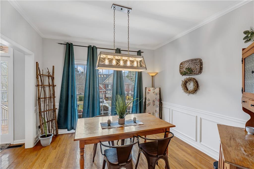860 Valley Drive Canton, GA 30114 - Photo 19 of 62 a view of a dining room with furniture window and wooden floor