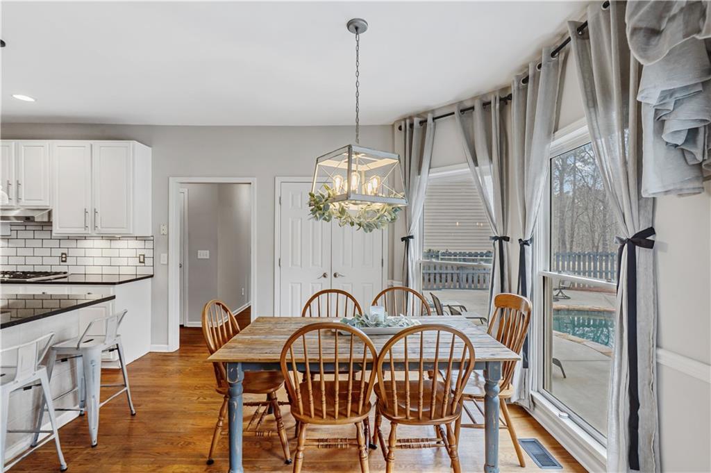 860 Valley Drive Canton, GA 30114 - Photo 21 of 62 a dining room with furniture a chandelier and wooden floor