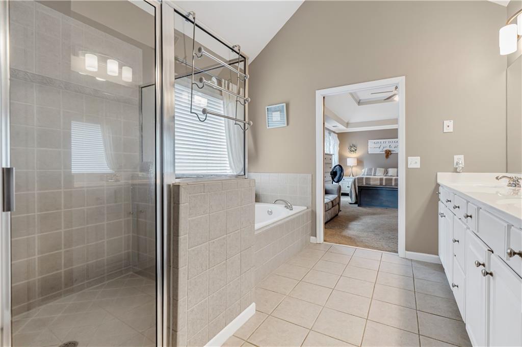 860 Valley Drive Canton, GA 30114 - Photo 26 of 62 a bathroom with a glass door shower a sink and a mirror