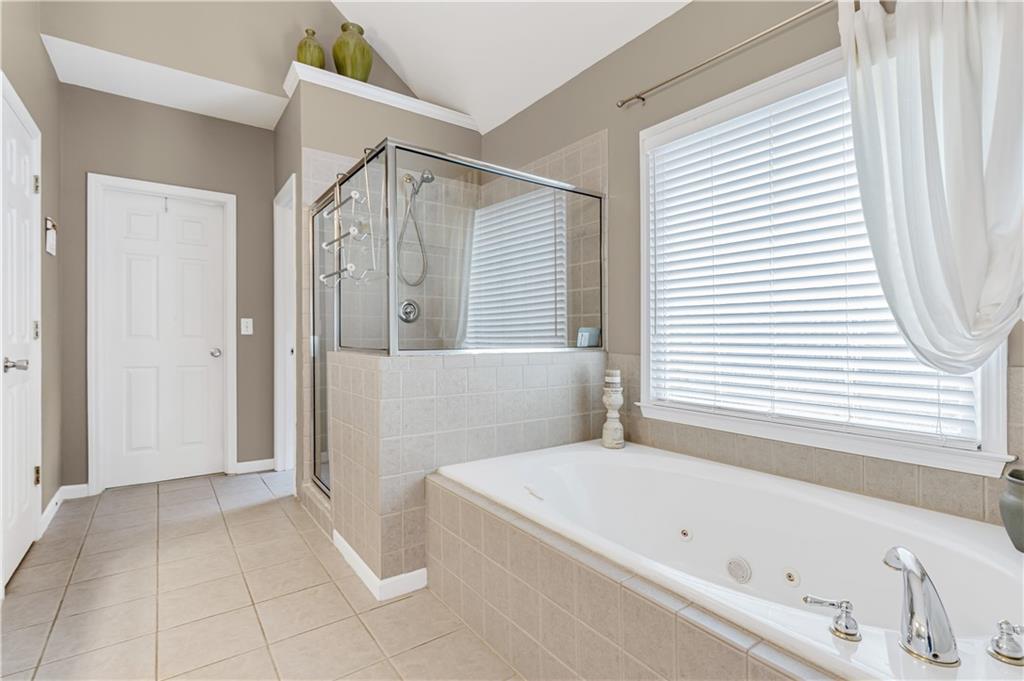860 Valley Drive Canton, GA 30114 - Photo 27 of 62 a bathroom with a bathtub and a shower