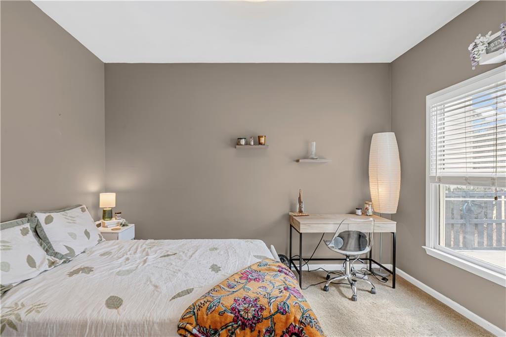 860 Valley Drive Canton, GA 30114 - Photo 28 of 62 a bedroom with a bed and a table chair