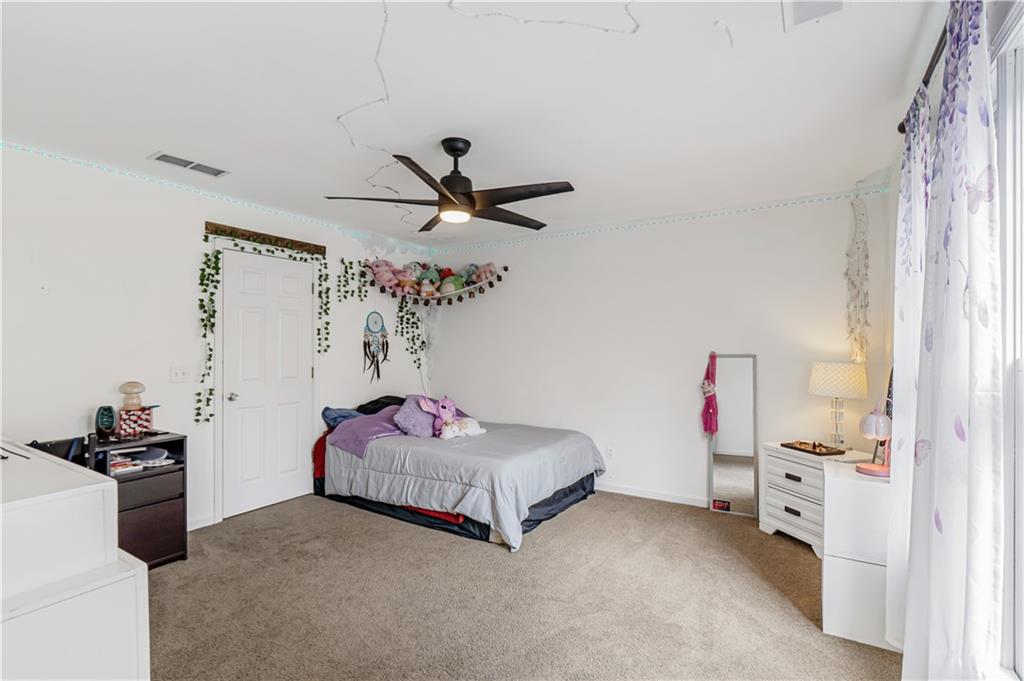 860 Valley Drive Canton, GA 30114 - Photo 33 of 62 a bedroom with a bed and a chandelier