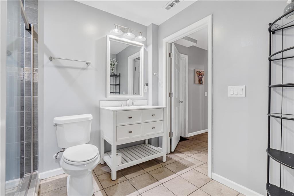 860 Valley Drive Canton, GA 30114 - Photo 35 of 62 a bathroom with a toilet a sink and a mirror