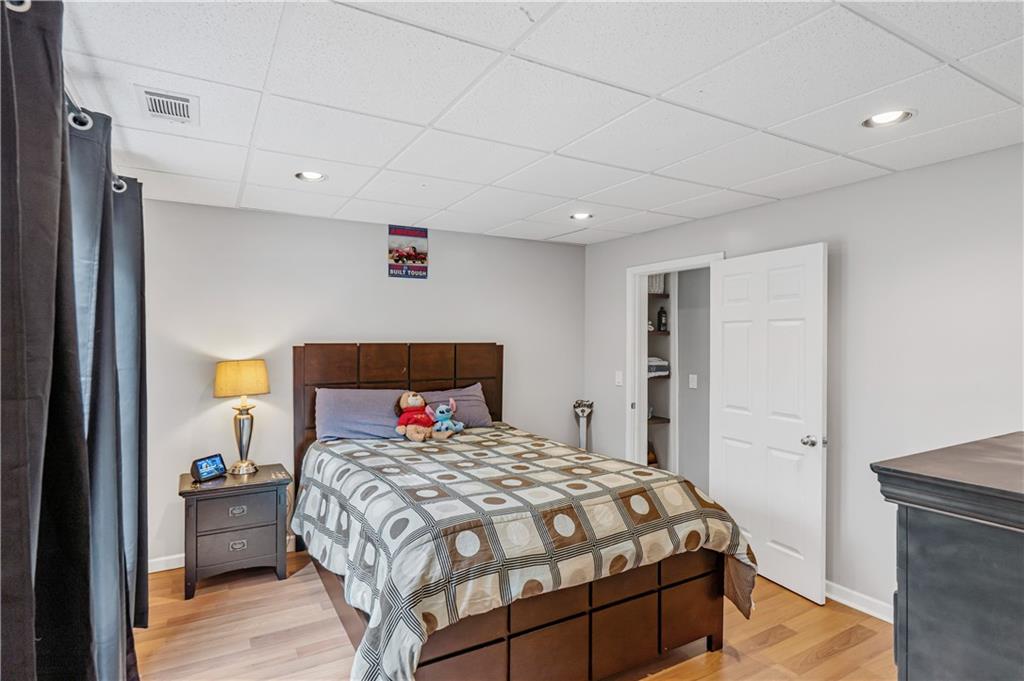 860 Valley Drive Canton, GA 30114 - Photo 37 of 62 a bedroom with a bed and a painting on the wall