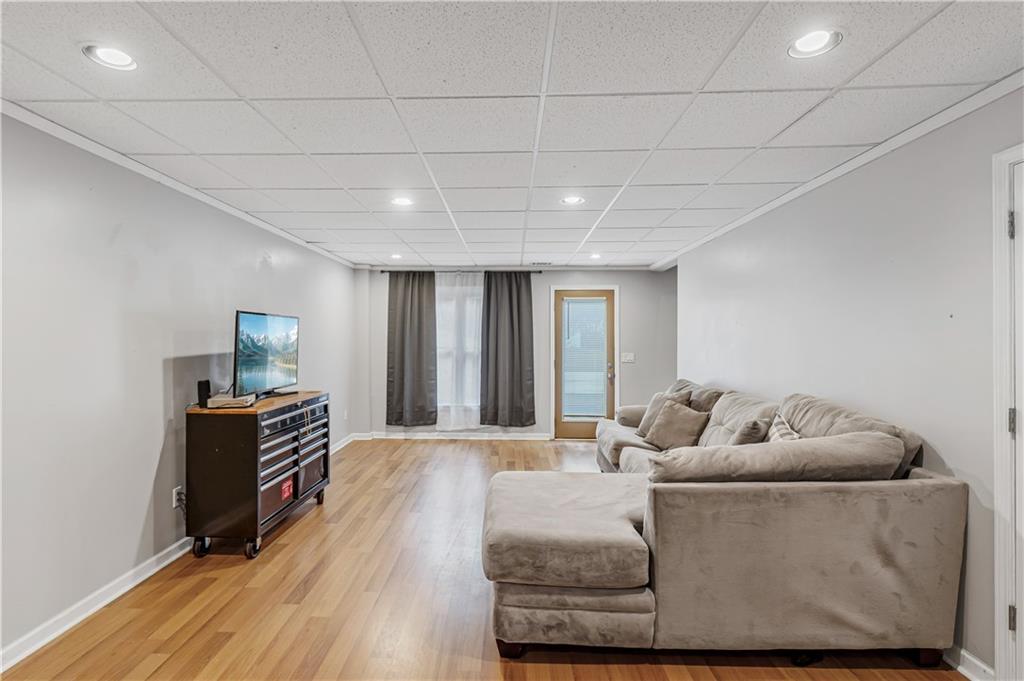 860 Valley Drive Canton, GA 30114 - Photo 40 of 62 a living room with furniture and wooden floor
