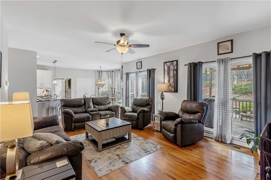 860 Valley Drive Canton, GA 30114 - Photo 10 of 62 a living room with furniture ceiling fan and a wooden floor