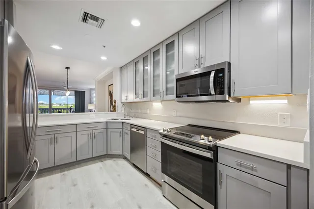 a kitchen with granite countertop stainless steel appliances and sink