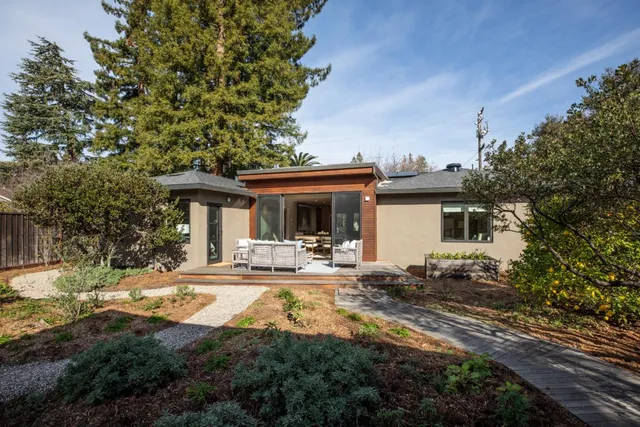 a view of a house with swimming pool and sitting area