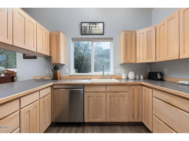 a kitchen with granite countertop white cabinets and stainless steel appliances