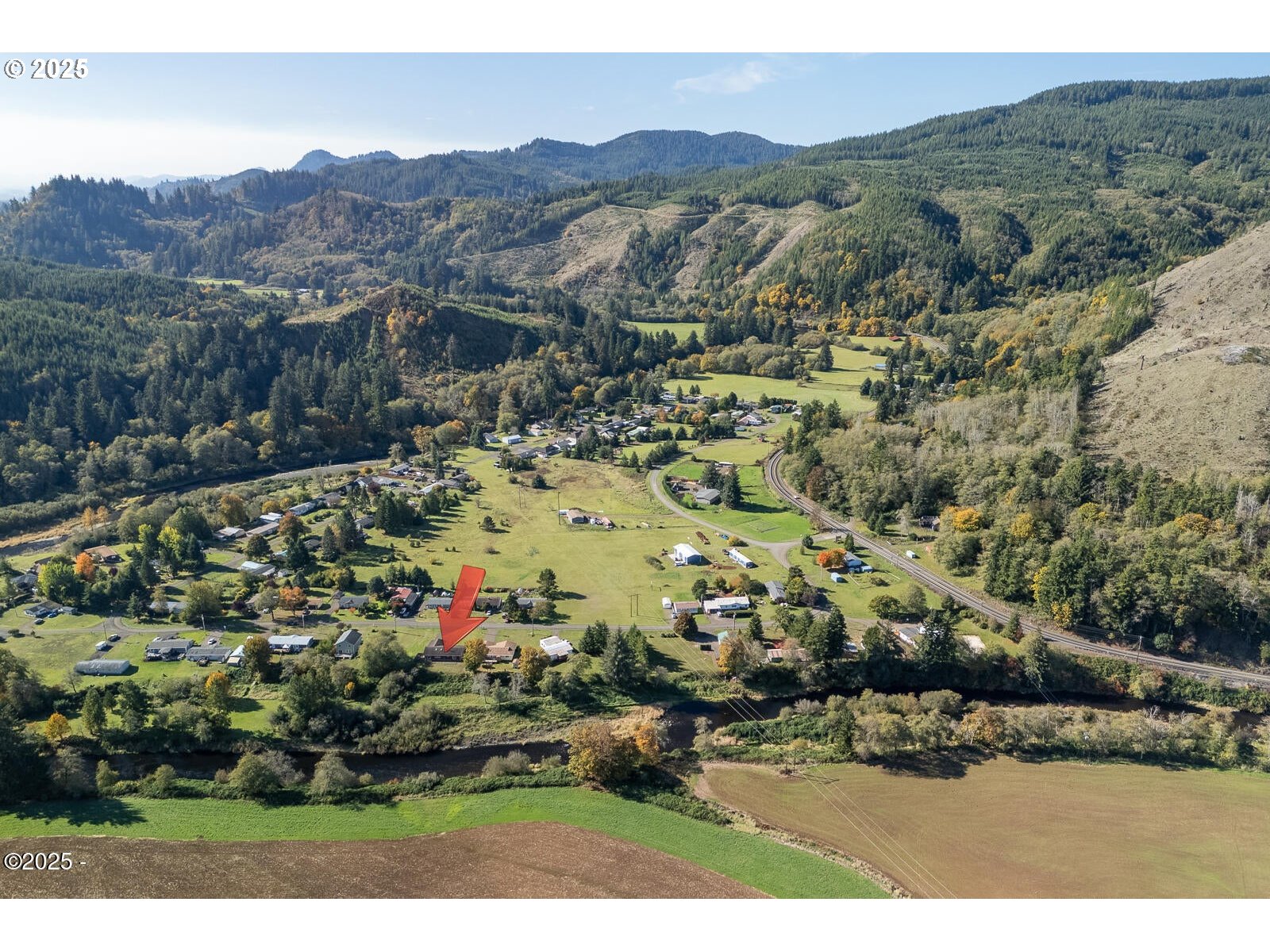25855 Chinook Street Cloverdale, OR 97112 - Photo 25 of 26 a view of a town with mountains in the background