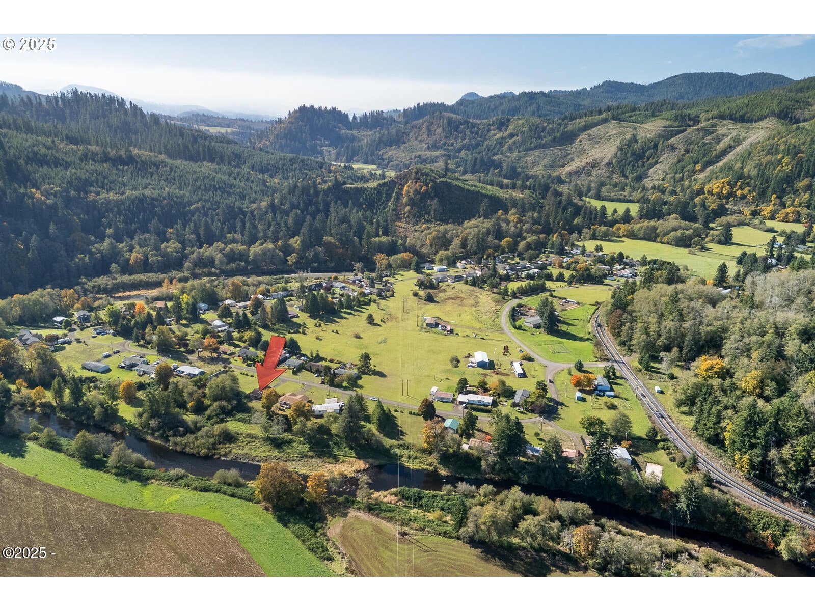25855 Chinook Street Cloverdale, OR 97112 - Photo 26 of 26 a view of a town with mountains in the background
