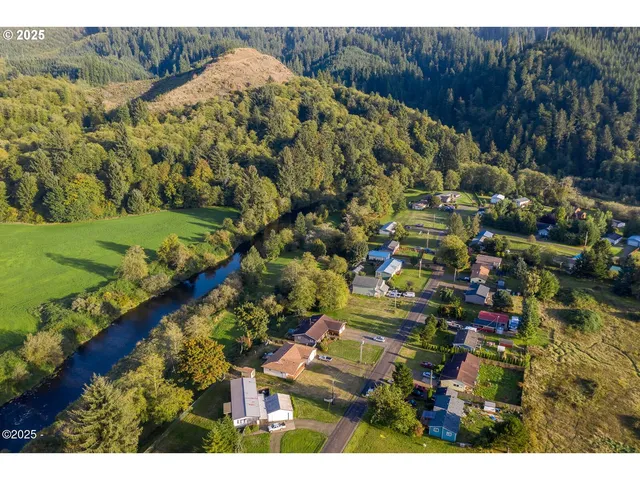 a backyard of a house with a yard and outdoor seating