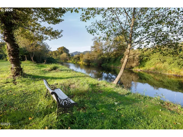a view of a hallway with wooden floor and closet