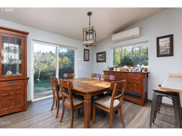 a kitchen with stainless steel appliances a sink a stove a refrigerator cabinets and a window