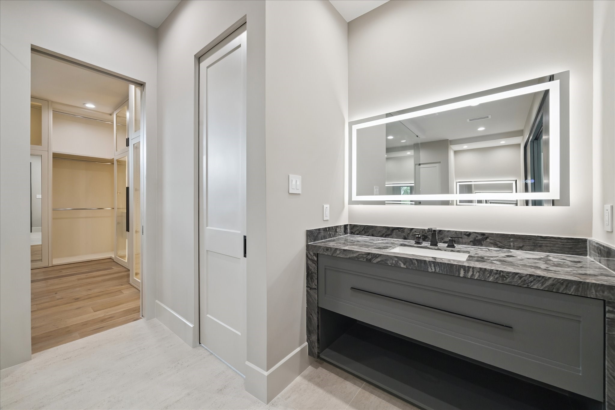 2120 Branard Street Houston, TX 77098 - Photo 19 of 33 Sleek fixtures, textured wall accents, and abundant natural light enhance the sophisticated ambiance, making this bathroom a true retreat.