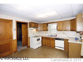 334 Queentown Road Canton, NC 28716 - Photo 4 of 9 a kitchen with stainless steel appliances granite countertop a stove a sink dishwasher and a refrigerator