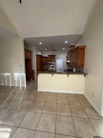 a view of kitchen with granite countertop lots of counter top space and appliances