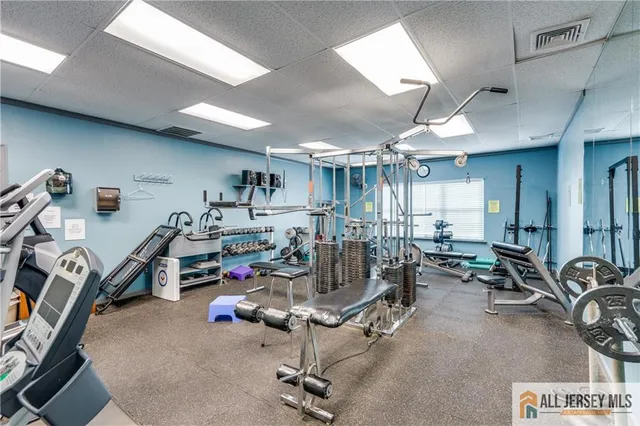 a room with gym equipment and a large window