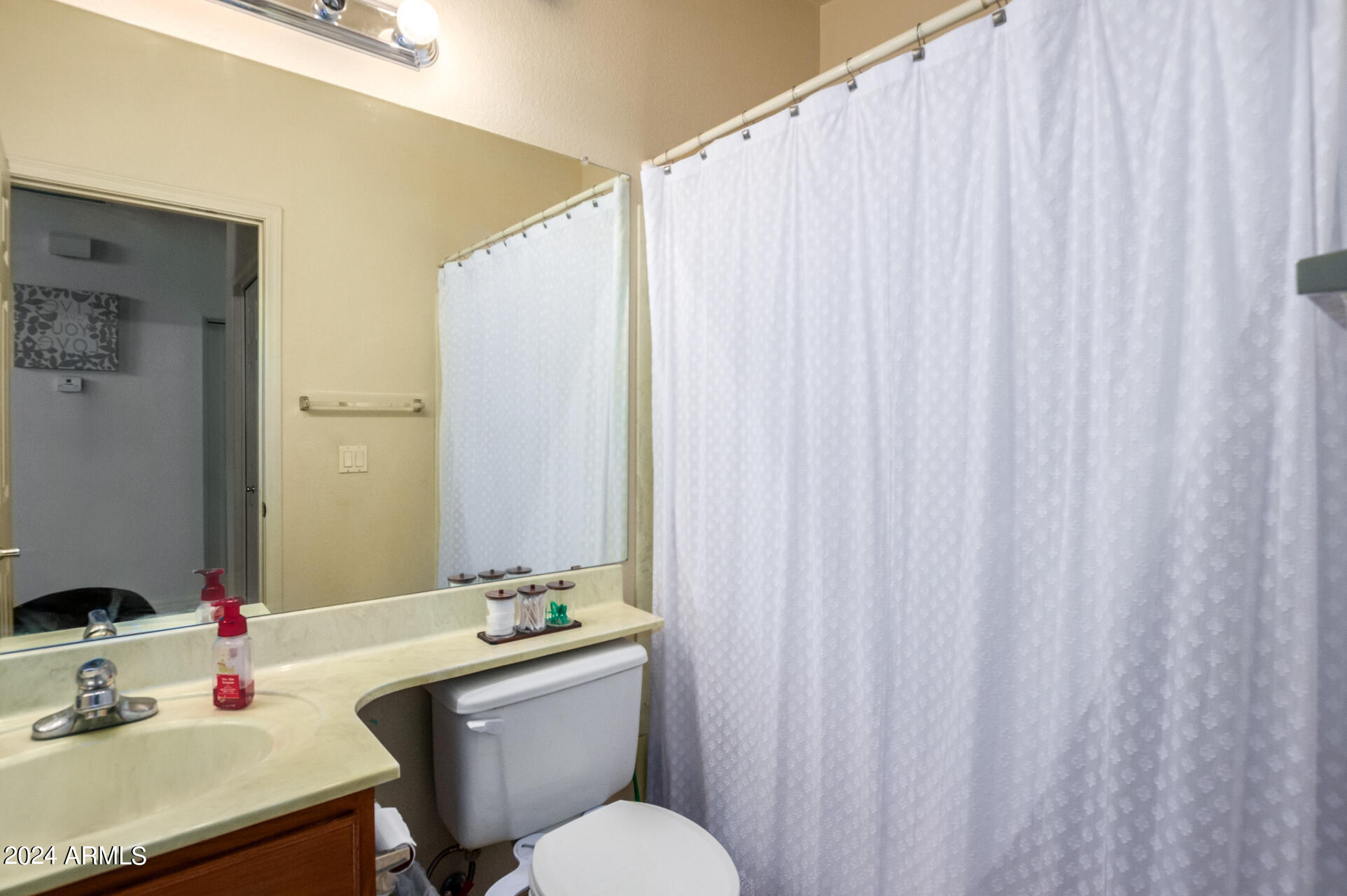 2801 North Litchfield Road, Unit 18 Goodyear, AZ 85395 - Photo 17 of 23 a bathroom with a sink a toilet and mirror