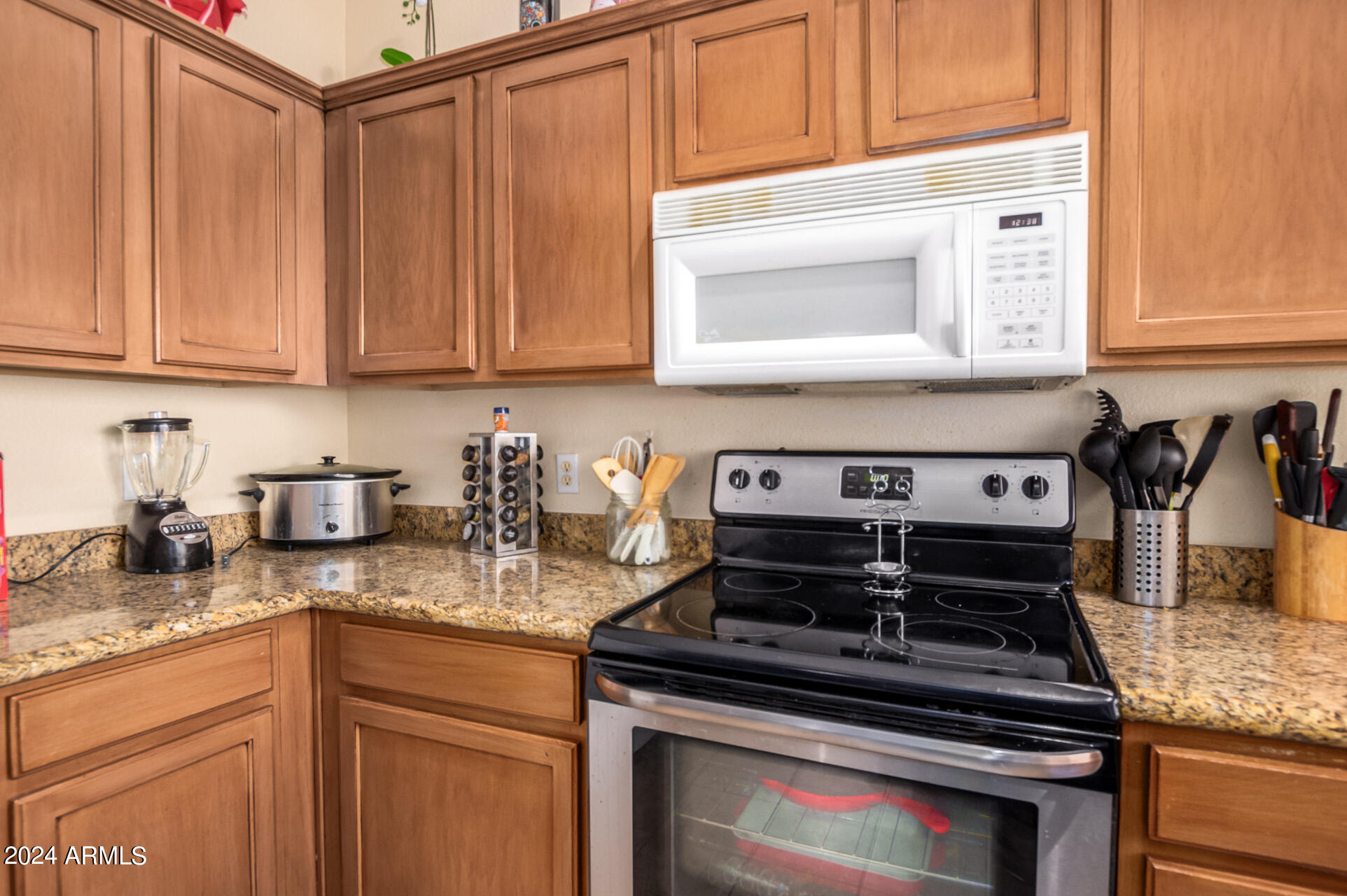 2801 North Litchfield Road, Unit 18 Goodyear, AZ 85395 - Photo 7 of 23 a kitchen with stainless steel appliances granite countertop a stove and a sink