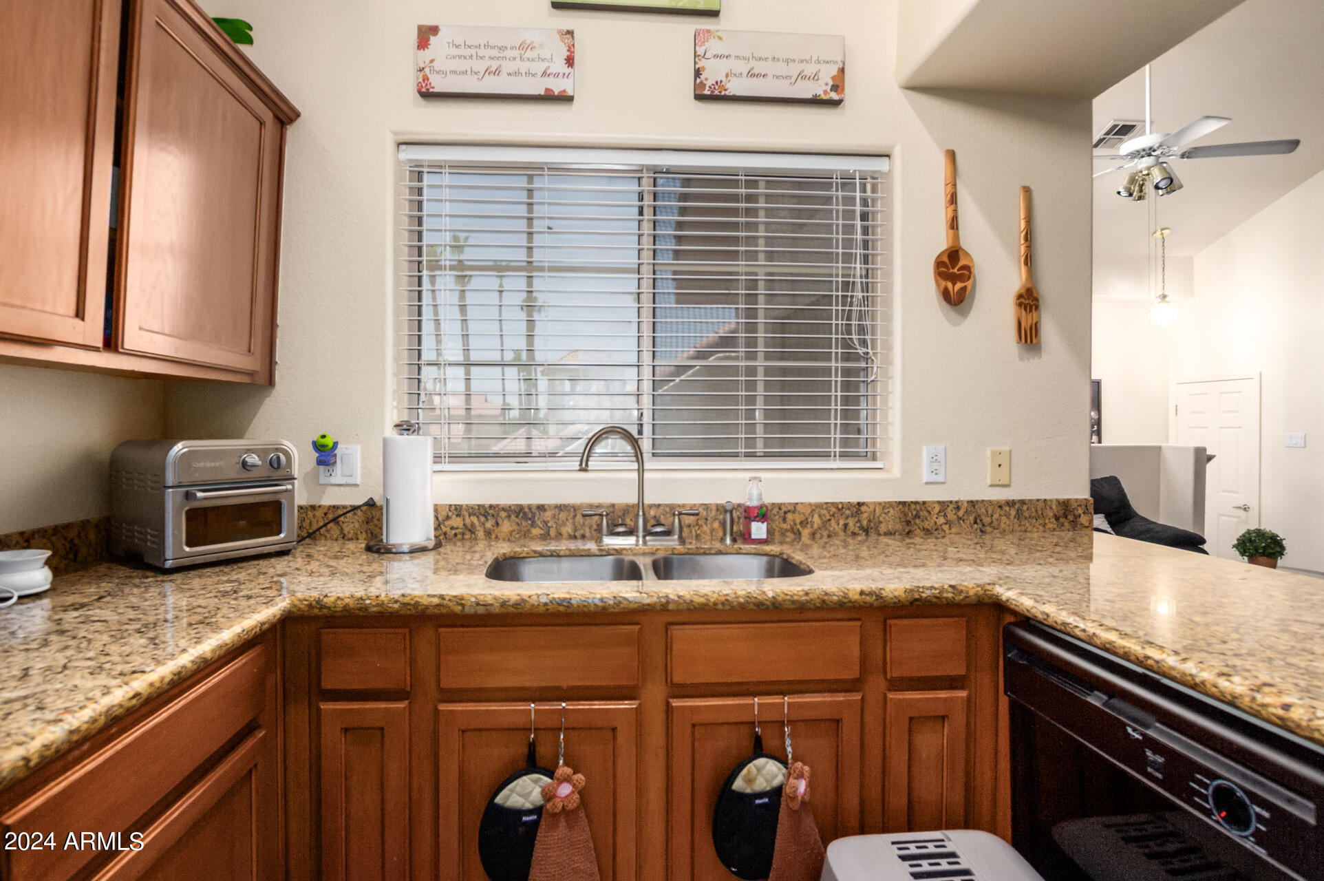 2801 North Litchfield Road, Unit 18 Goodyear, AZ 85395 - Photo 8 of 23 a kitchen with granite countertop a sink a stove and cabinets