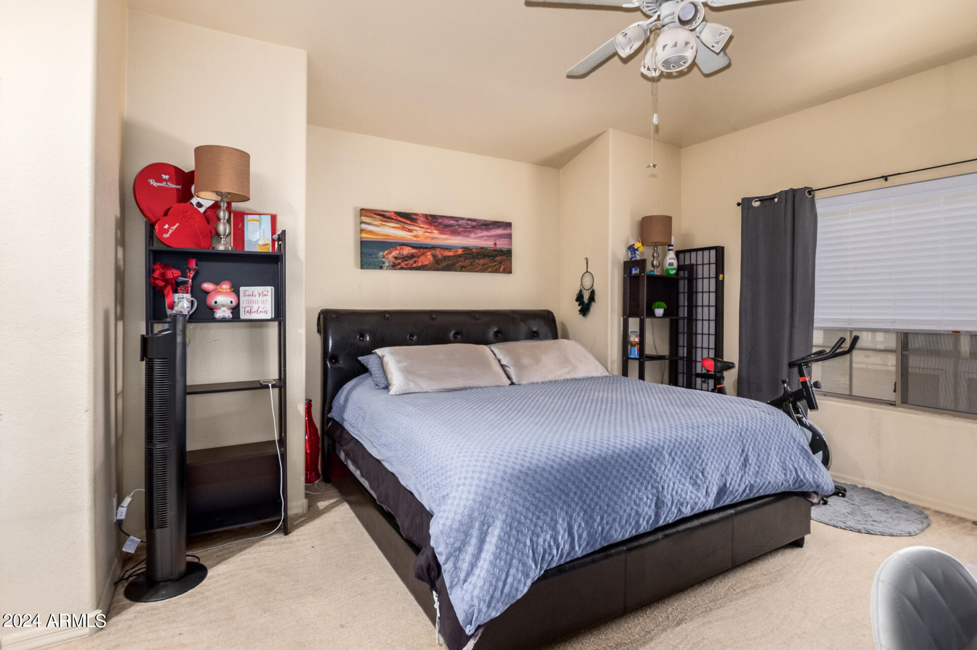 2801 North Litchfield Road, Unit 18 Goodyear, AZ 85395 - Photo 9 of 23 a bedroom with a bed and a chandelier
