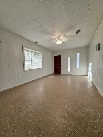 a view of an empty room with windows