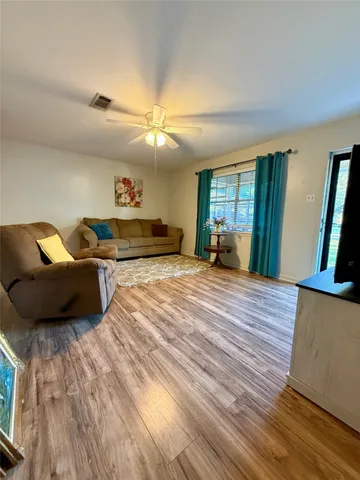 a spacious bedroom with a bed and a large mirror