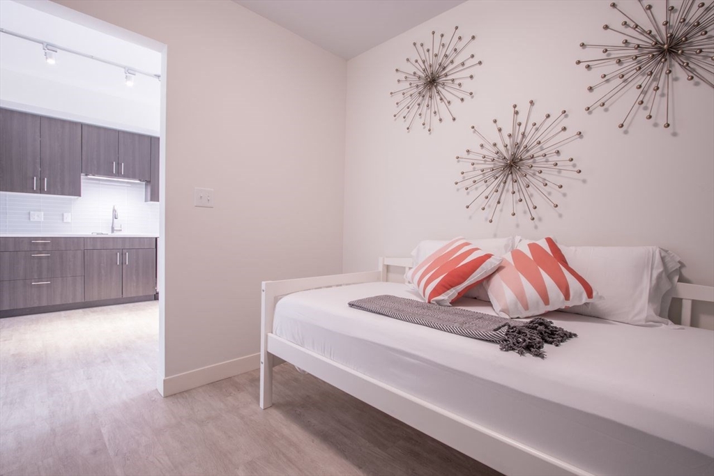 900 Beacon Street, Unit 408 Boston, MA 02215 - Photo 11 of 12 a room with a bed and a painting on the wall